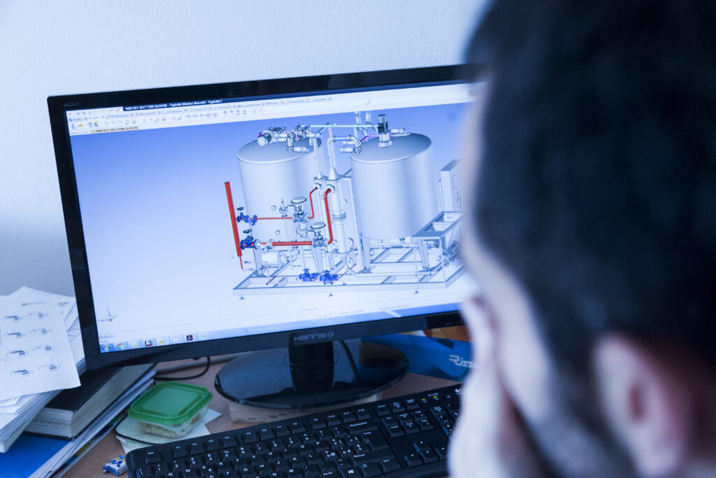 INOX-FER technician analyzing industrial plant layout on screen
